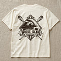 Outport crest on the back of an ivory Woods Island Outfitters tee